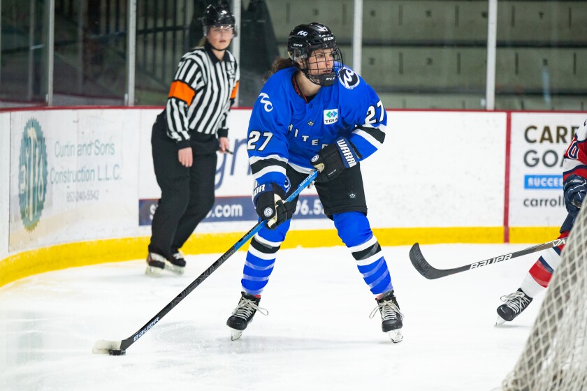 Minnesota Whitecaps player behind Riveters' goal.