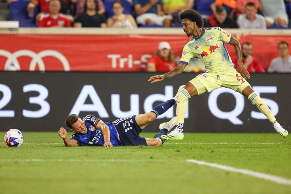 Jul 12, 2023; Harrison, New Jersey, USA; FC Cincinnati defender Santiago Arias (13) is fouled by New York Red Bulls defender Kyle Duncan (6) during the second half at Red Bull Arena. Mandatory Credit: Vincent Carchietta-USA TODAY Sports