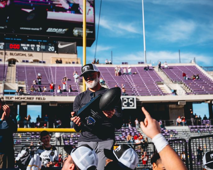 12/27/24 Fort Worth, TX Amon G. Carter Stadium| Navy Head Coach Newberry lifting Armed Forces Trophy. Mandatory Credit: Navy Midshipmen