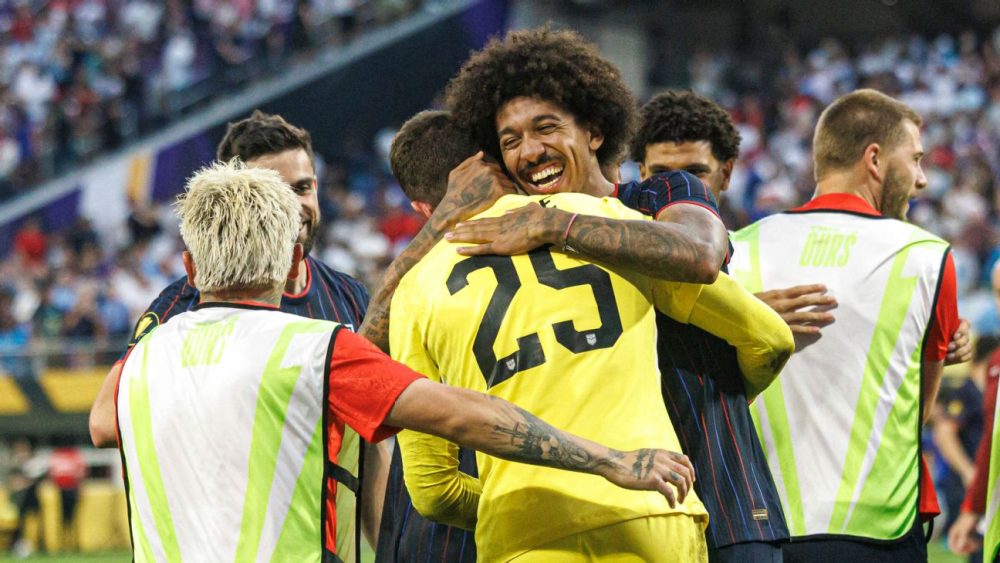 6/29/25 Chris Richards and JMi embrace Matt Freese after his heroic stand-in goal during the penalty shootout against Costa Rica. Mandatory Credit: Getty Images