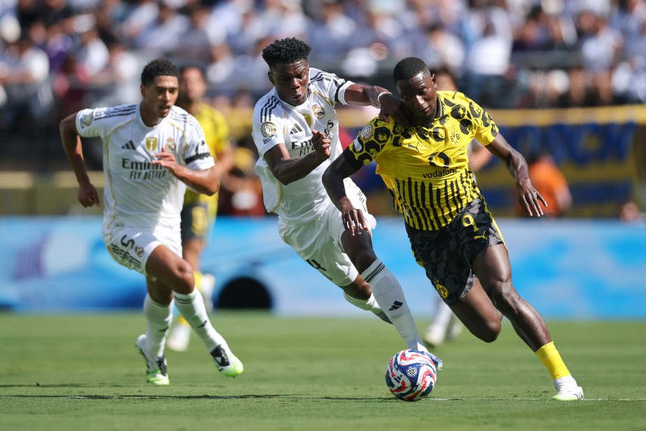 EAST RUTHERFORD, NEW JERSEY - JULY 05: Serhou Guirassy #9 of Borussia Dortmund is challenged by Aurelien Tchouameni #14 of Real Madrid during the FIFA Club World Cup 2025 quarter-final match between Real Madrid CF and Borussia Dortmund at MetLife Stadium on July 05, 2025 in East Rutherford, New Jersey. (Photo by Hector Vivas - FIFA/FIFA via Getty Images)