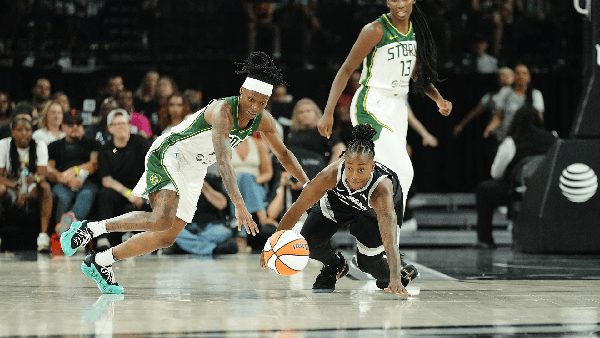 Jewell Loyd of the Seattle Storm dives for a loose ball against Las Vegas Aces defender during WNBA game action