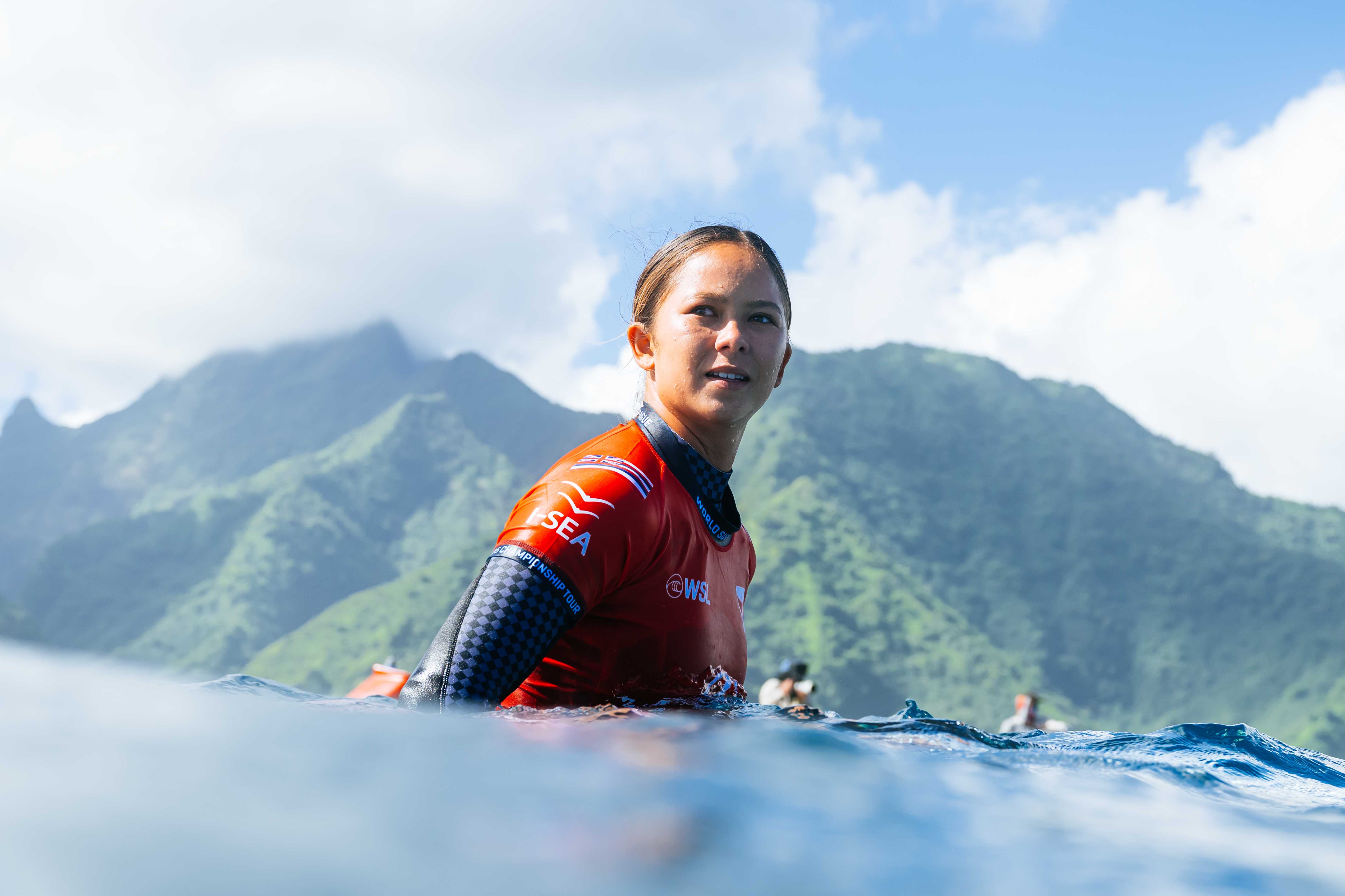 Bettylou Sakura Johnson in water at Lexus Tahiti Pro with Tahitian mountains in background