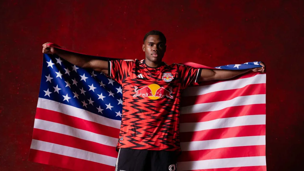Serge Ngoma Holding up a USA Flag for US U-20 Callup. Mandatory Credit New York Red Bulls