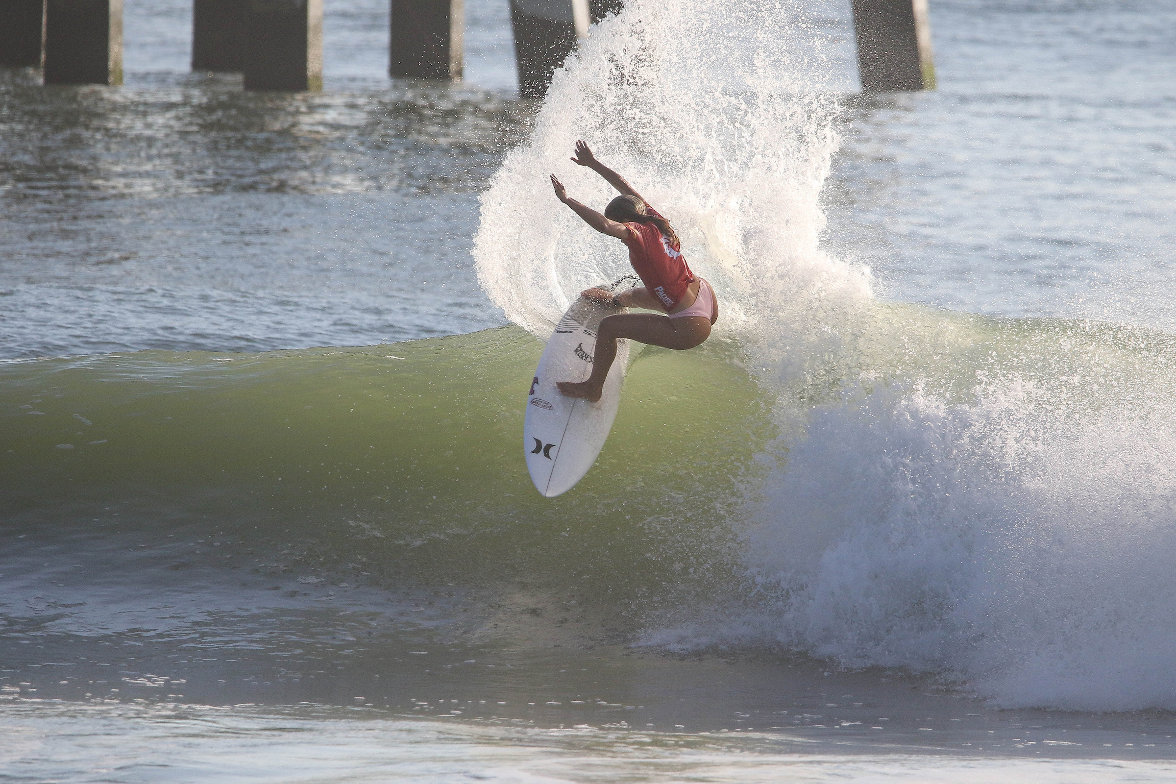 Zoe Benedetto performs powerful cutback maneuver during WRV Outer Banks Pro surfing competition at Jennette's Pier