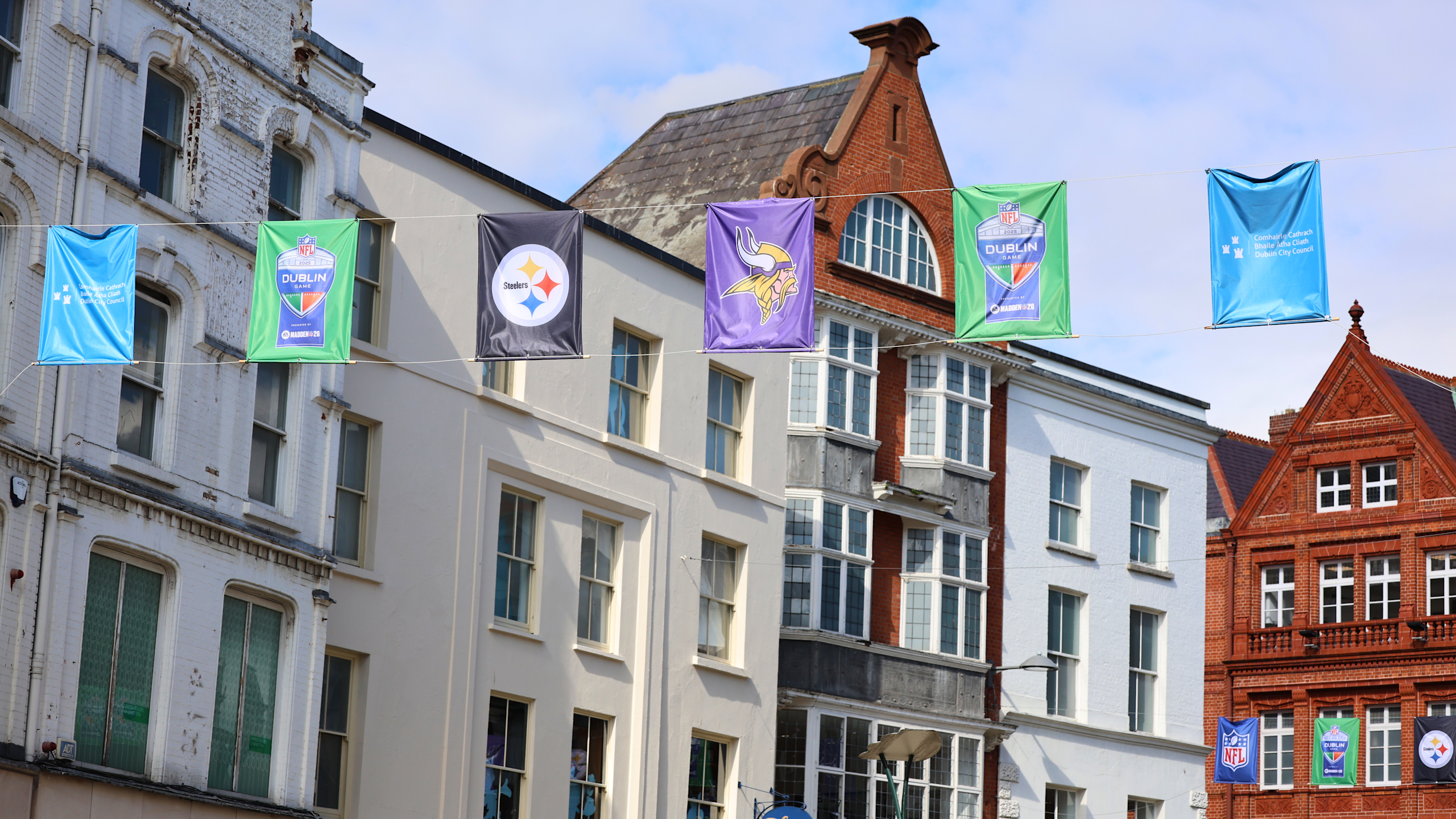 NFL team banners hanging from Dublin Ireland buildings promoting Vikings vs Steelers game