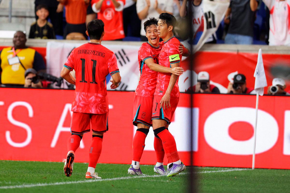 South Korean players celebrate Son Heung-Min's opening goal against the United States in red jerseys during international friendly match