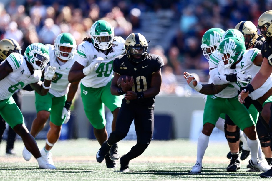 9/20/25, West Point , New York , Michie Stadium, Army quarterback Dewayne Coleman (#10) broke a tackle and gained yardage against North Texas. Mandatory Credit: Jose Pichirilo. Bad Dawg Sports