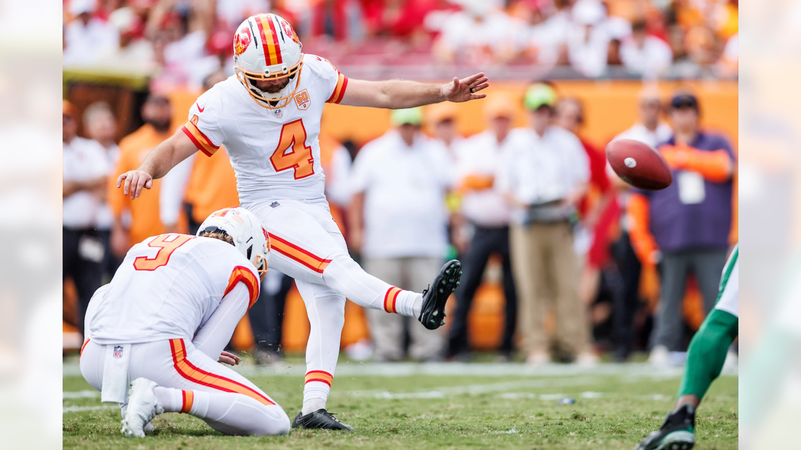 Tampa Bay Buccaneers punter Riley Dixon #9 holding football for kicker Chase McLaughlin #4 during game-winning field goal attempt in 29-27 victory over New York Jets