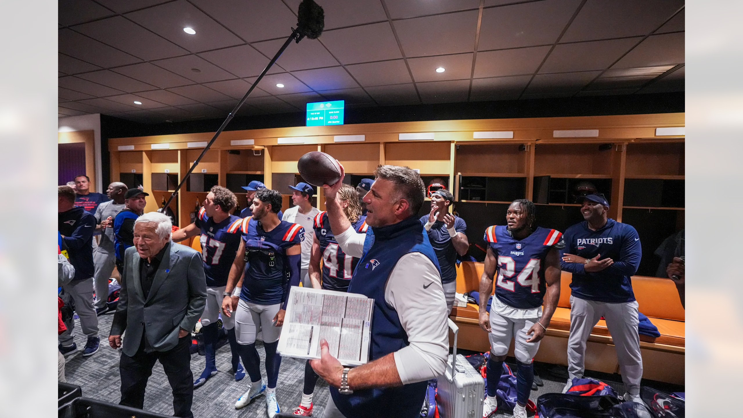 New England Patriots head coach Mike Vrabel and owner Robert Kraft celebrate in the locker room after the Patriots' 33-27 victory over the Miami Dolphins at Hard Rock Stadium