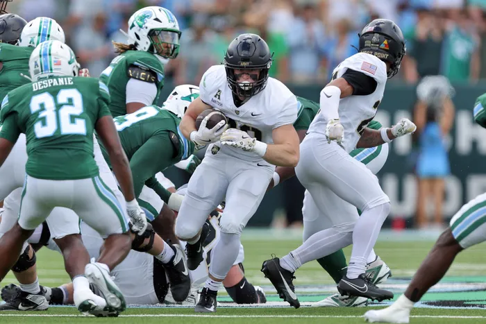 Army running back Briggs Bartosh (29) breaks through the line against Tulane during an American Conference matchup at Yulman Stadium, October 18, 2025. Photo credit: Army Athletics.