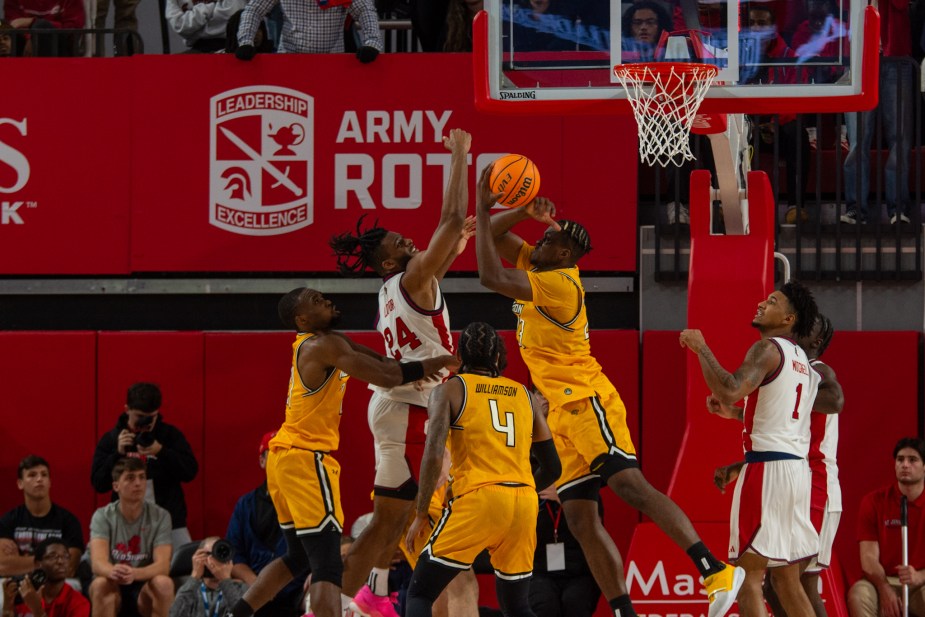 St. John's Red Storm forward Zuby Ejiofor blocks a Towson shot attempt during the second-half defensive showcase at Carnesecca Arena. Ejiofor's elite defense was crucial to St. John's' championship-level performance in the 73-63 victory.