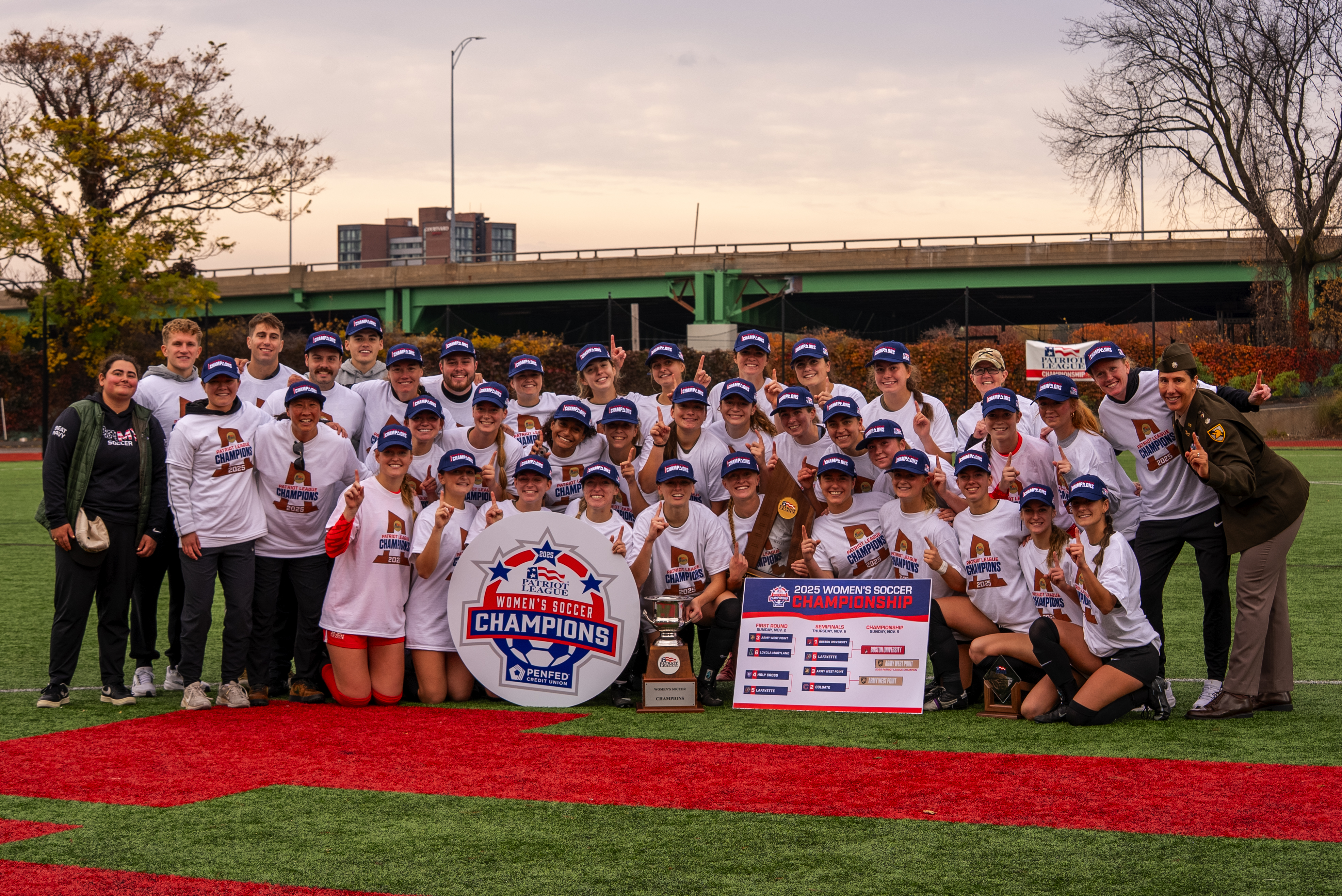 Army West Point Black Knights women's soccer team celebrates Patriot League Championship with trophy, banner, and championship gear after defeating Boston University 3-2 to earn NCAA Tournament berth