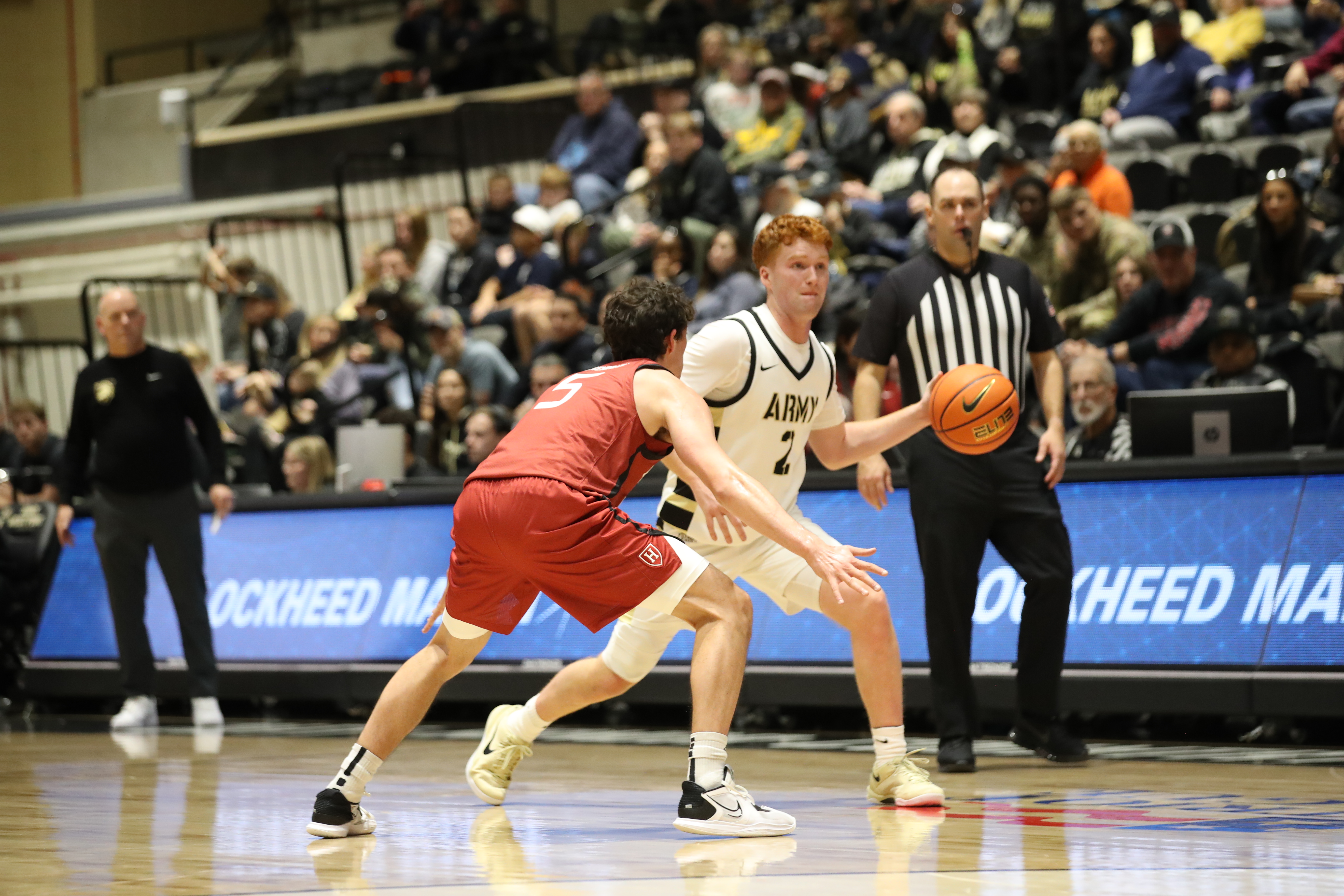 Army Black Knights Ryan Curry number 2 dribbles against Harvard Crimson pressure defense at Christl Arena