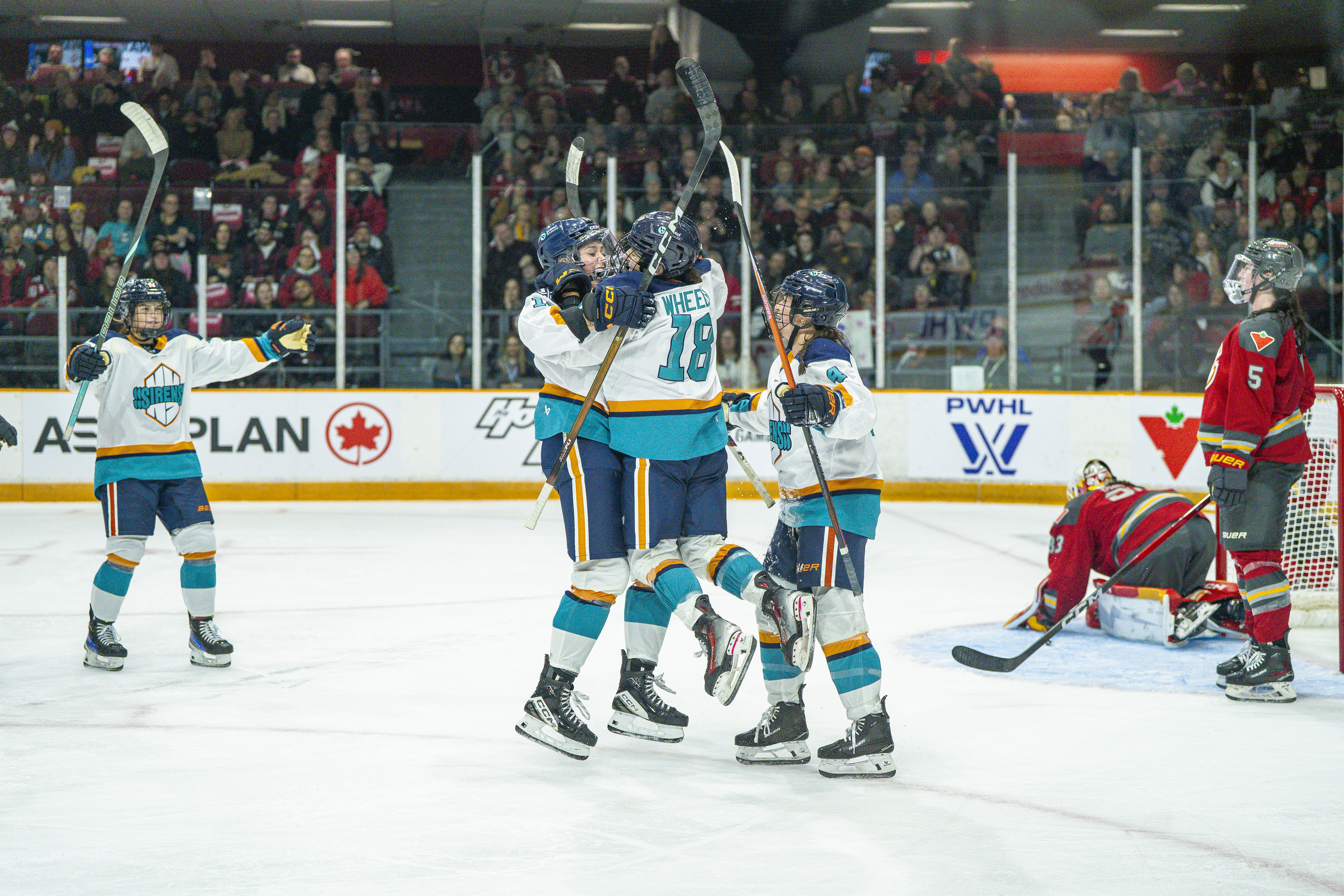 New York Sirens forward Taylor Girard celebrates her hat trick with rookie Maddi Wheeler, who assisted on all three goals, during the 2025-26 PWHL season opener against the Ottawa Charge at TD Place in Ottawa, Ontario, on November 22, 2025.