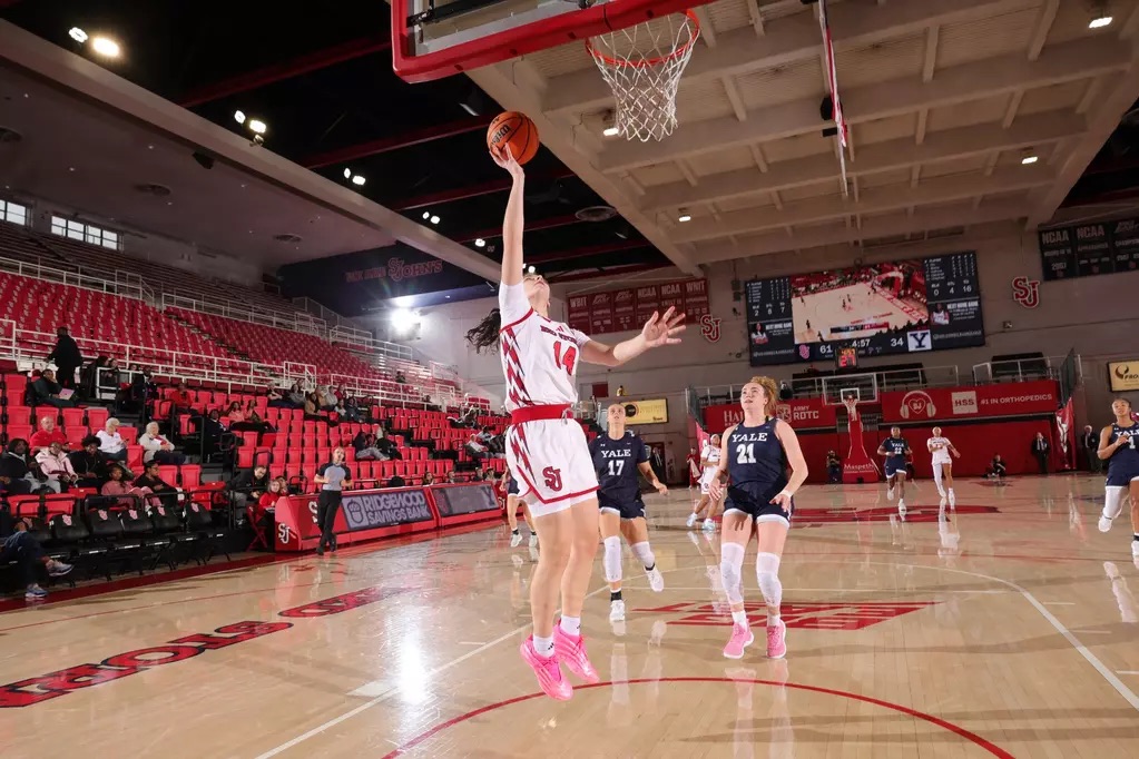 Kylie Lavelle number 14 of St. John's Red Storm women's basketball drives to the basket against Yale Bulldogs at Carnesecca Arena
