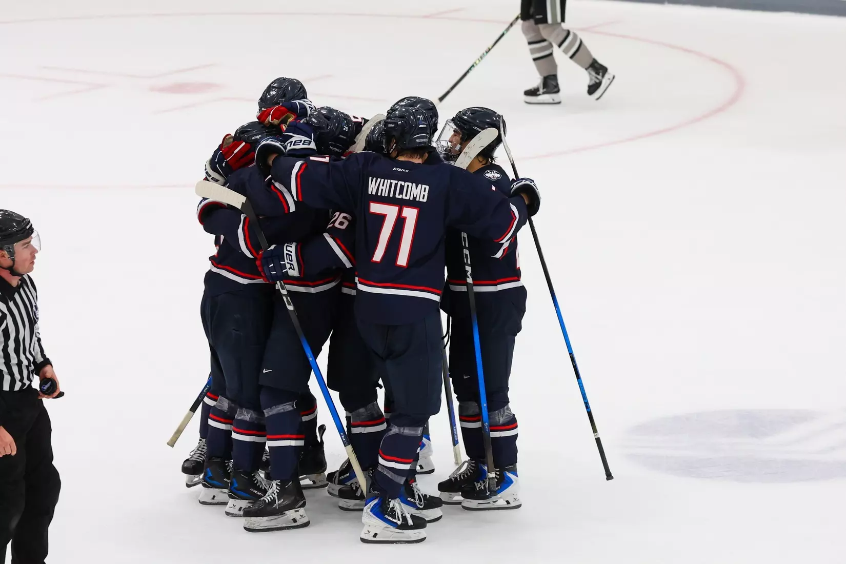 UConn Huskies men's ice hockey team celebrates together on ice after 4-1 victory over New Hampshire at Whittemore Center Arena, November 21, 2025