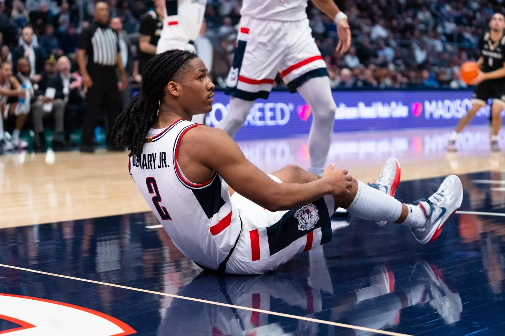 UConn guard Silas Demary Jr sits on court during game against Bryant at PeoplesBank Arena