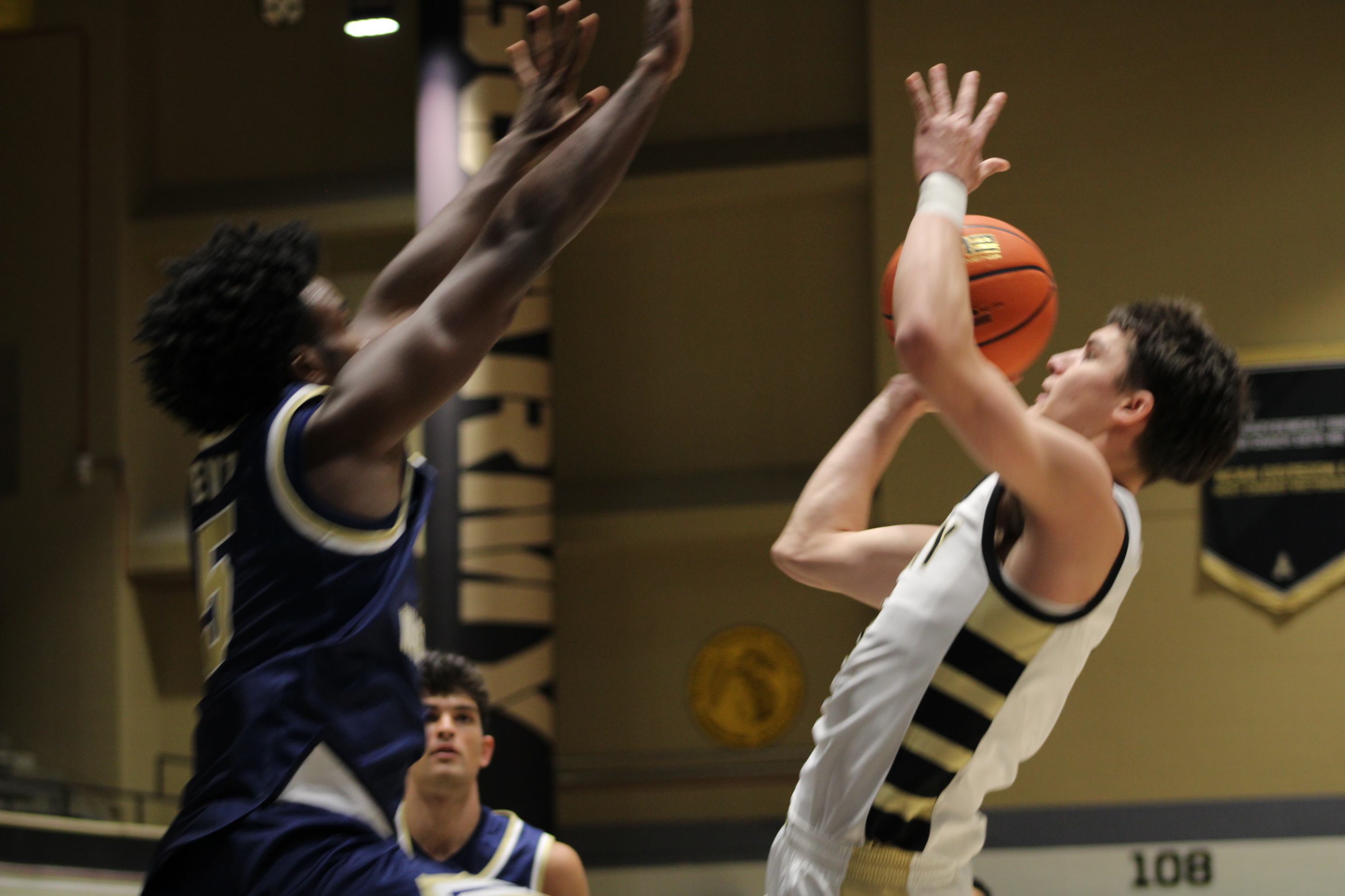 Army West Point freshman guard Jackson Furman pulls up for a contested jumper near the basket against a George Washington defender during the Black Knights' 84-70 loss at Christl Arena on December 2, 2025.