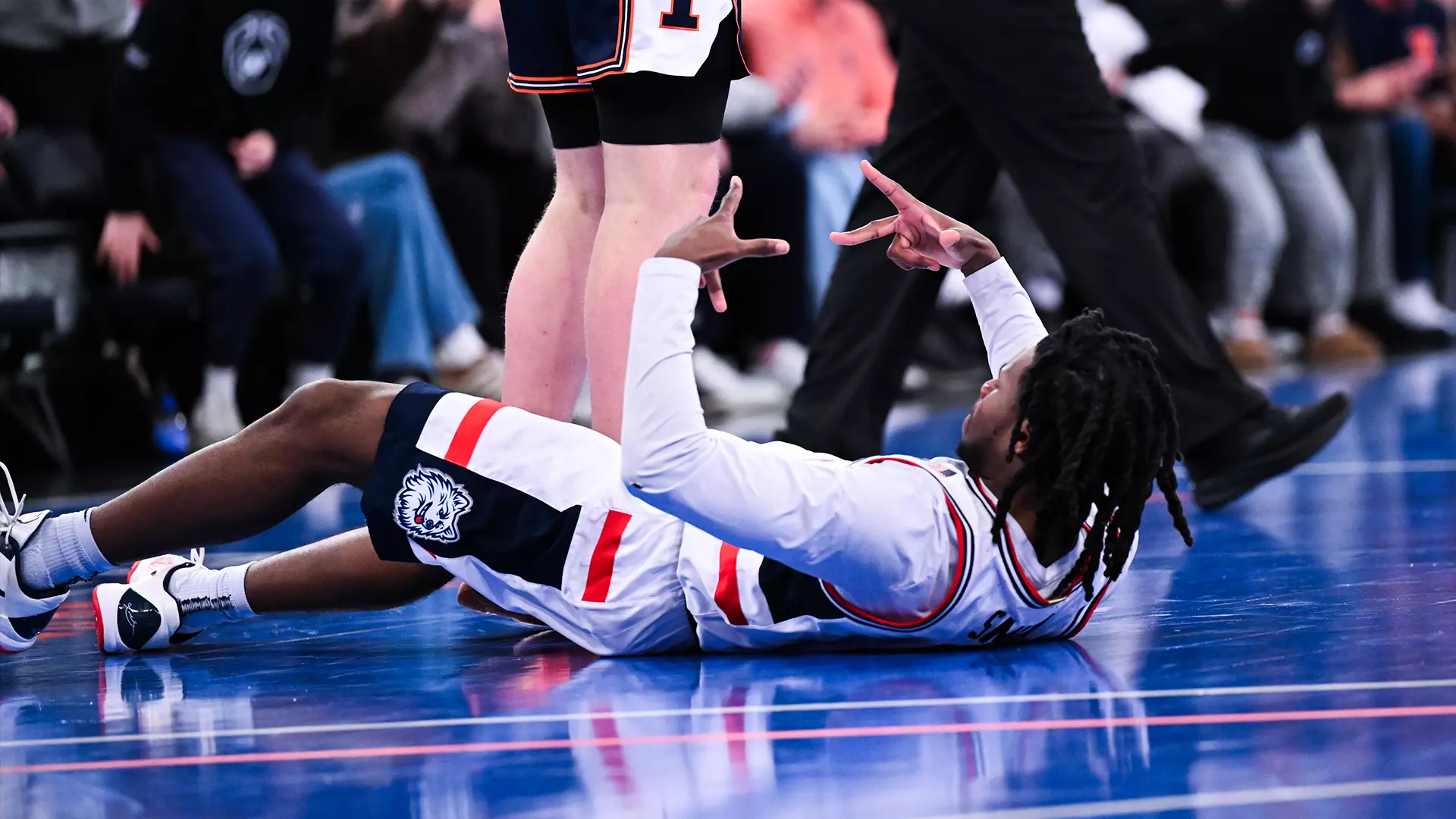 UConn Huskies player celebrates on court at Madison Square Garden during 74-61 victory over Illinois in SentinelOne Showdown