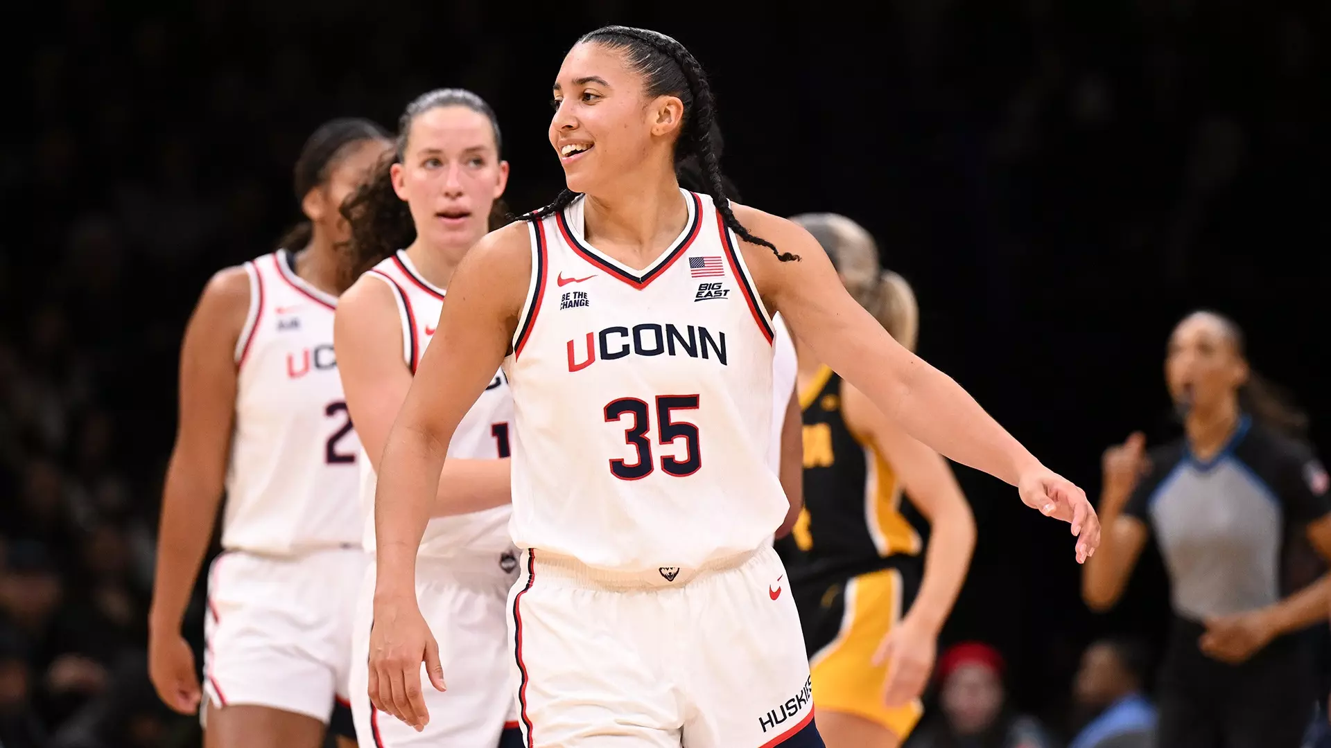 UConn women’s basketball player Azzi Fudd (#35) smiles and celebrates on court with teammates during the Champions Classic against Iowa.