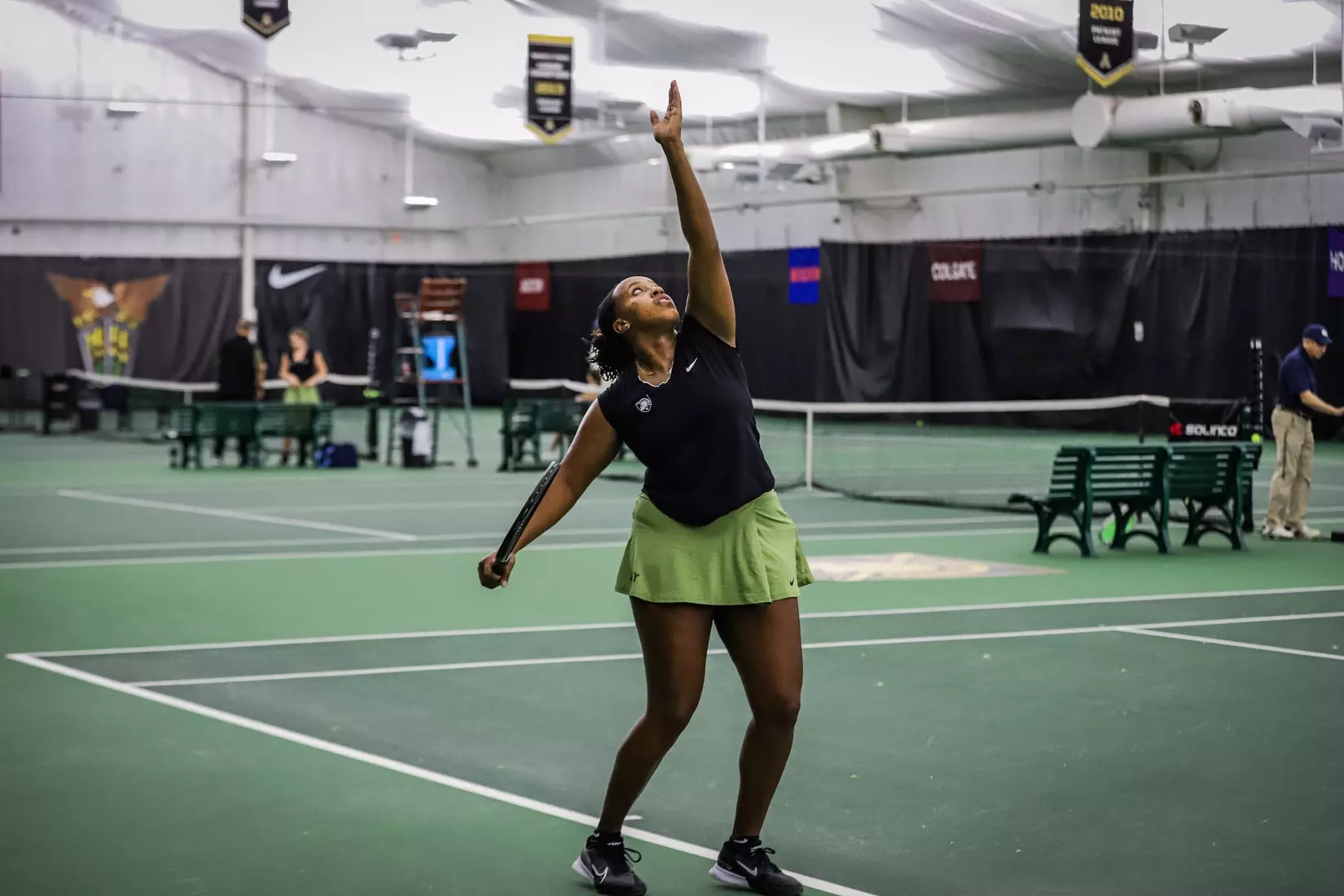 Army West Point women’s tennis player tosses the ball to serve during a match at Lichtenberg Tennis Center.