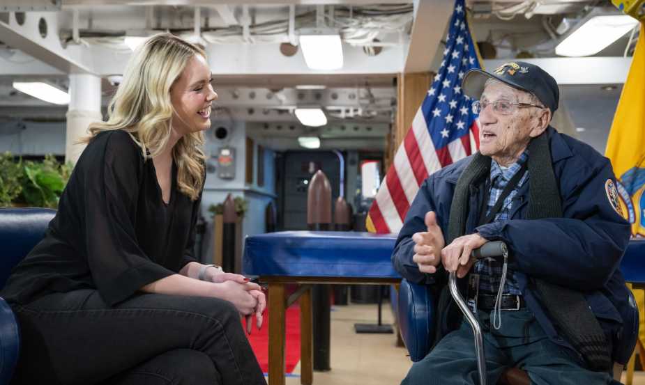WWII Navy veteran John “Johnny Q” Quinesso Sr. speaks with an interviewer during his 100th birthday celebration aboard the Battleship New Jersey Museum in Camden, N.J.
