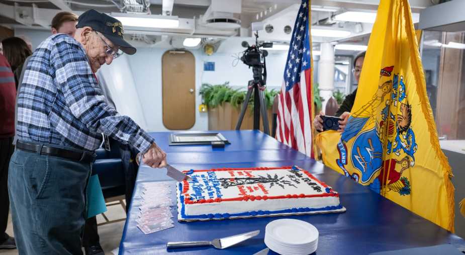 WWII Navy veteran John “Johnny Q” Quinesso Sr. cuts a birthday cake during his 100th birthday celebration aboard the Battleship New Jersey Museum in Camden, N.J.
