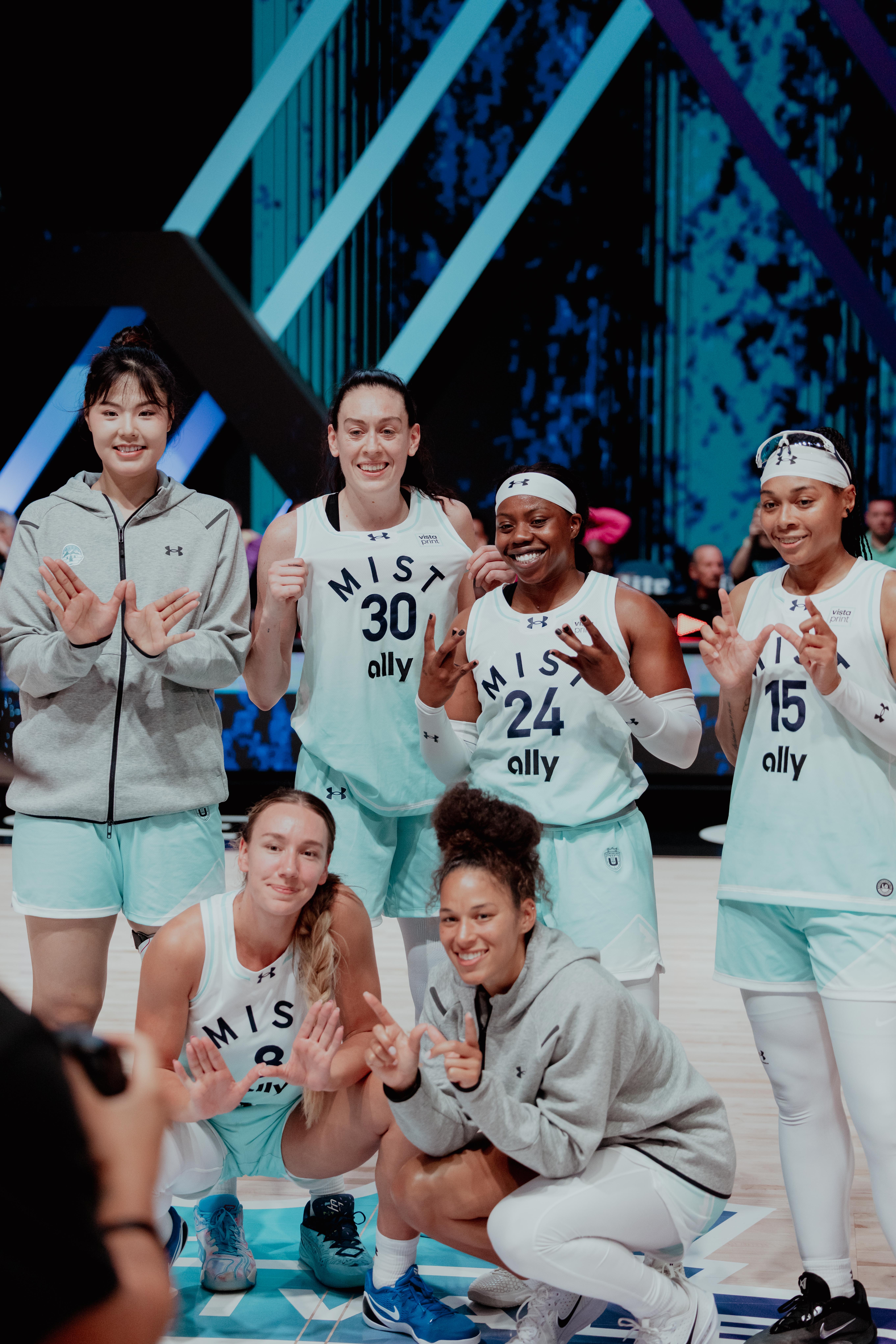 Mist BC players, including Li Yueru, Breanna Stewart, Arike Ogunbowale, Allisha Gray, Alanna Smith, and Veronica Burton, pose for a team photo following their 92-73 victory over Lunar Owls BC at Sephora Arena in Miami.