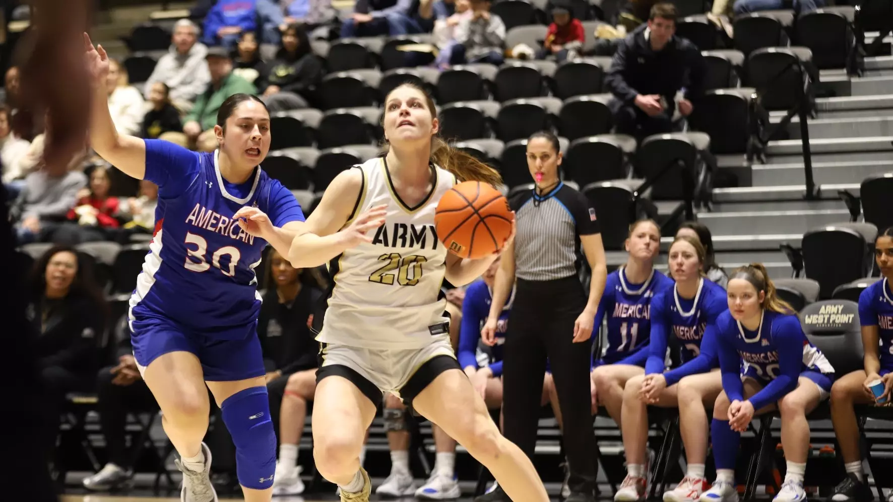 Army West Point guard Camryn Tade drives under the basket against American University at West Point.